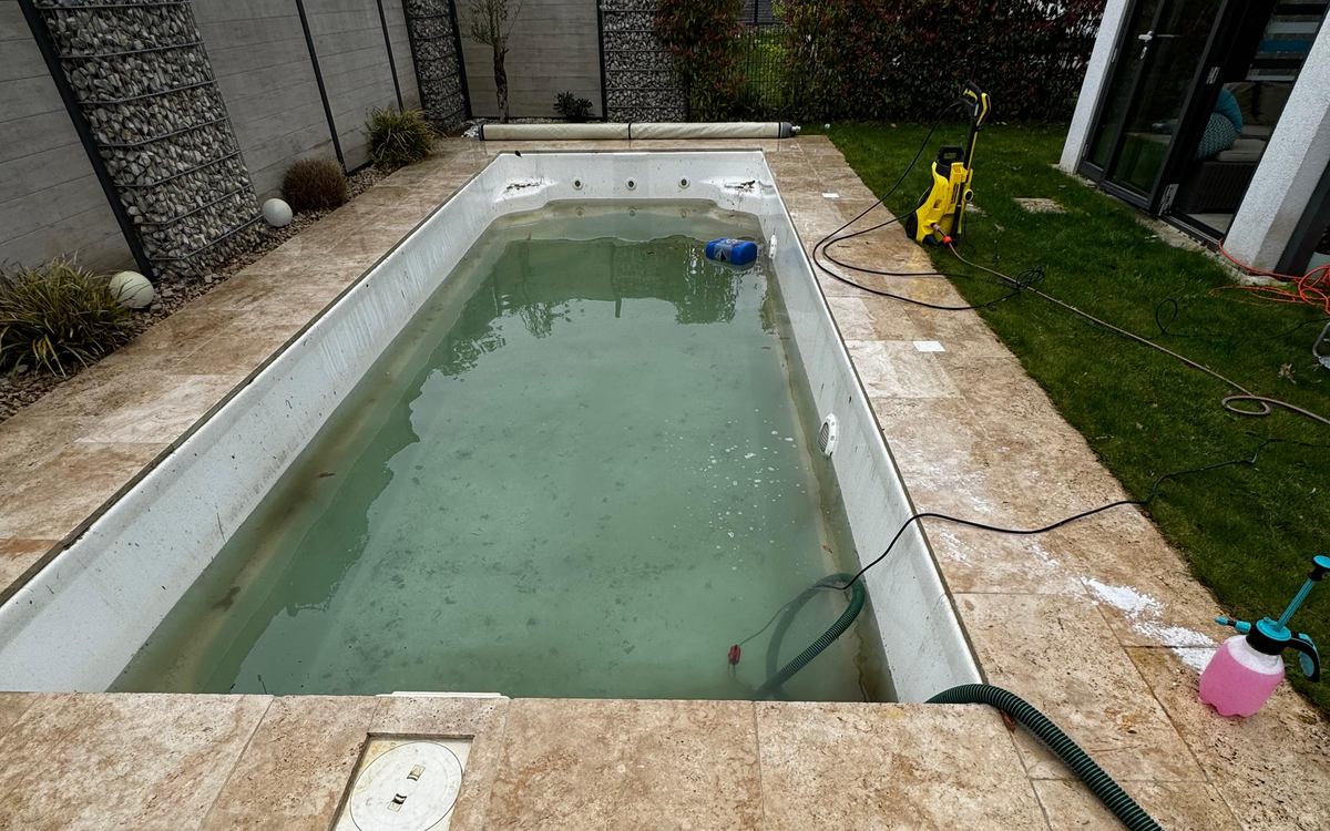 Pool mit trübem grüngrauem Wasser und verschmutzten Beckenwänden vor der Reinigung
